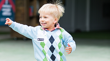 Young boy smiling in front of Church