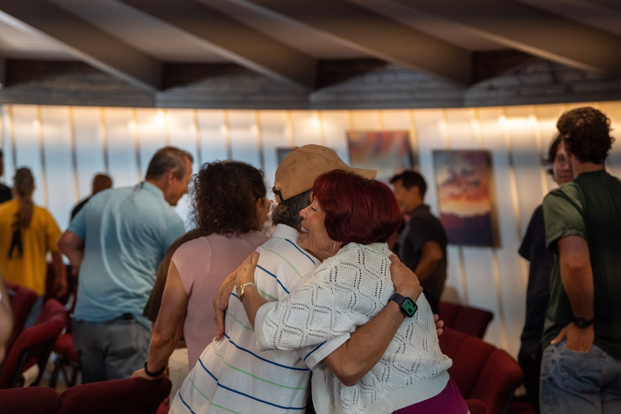 Two women share a hug after the service