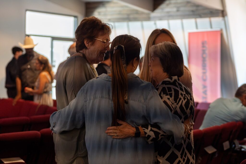 Friends share a group hug in the sanctuary